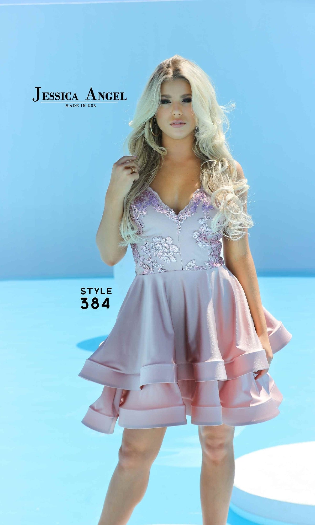 A woman in a light purple sleeveless Embroidered-Bodice Short Tiered Hoco Dress 384 with sequin details stands before a blue background. Text reads